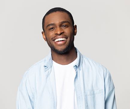 Man in pale blue shirt smiling